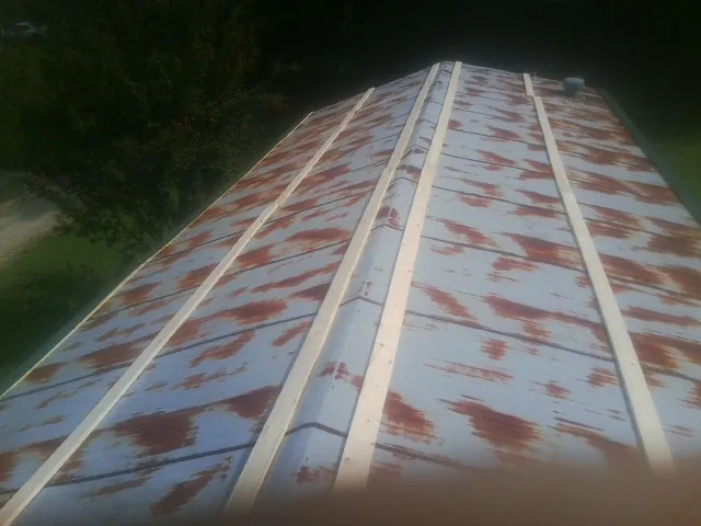 Rusted metal roof panels with new wood purlins before replacement — Storm Damage Roof Repair in Deferiet by Roofing Brothers